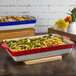 A Tuxton rectangular casserole dish with green beans and pasta in it.