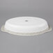 A white oval Tuxton China casserole dish with a white cover.