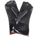 A pair of black neoprene oven mitts with red trim.