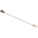 An antique copper-plated stainless steel Barfly bar spoon with a fork on the end.