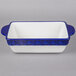 A white rectangular china casserole dish with cobalt blue accents.