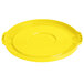A yellow plastic lid for a Lavex commercial trash can with a circle in the middle.