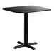 A black square Lancaster Table & Seating table with a cast iron base.