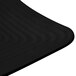 A black melamine square plate with a curved edge on a black surface.