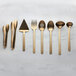 A group of American Metalcraft hammered gold vintage slotted spoons.