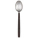 An American Metalcraft stainless steel slotted spoon with a wavy design and a wooden handle.