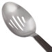 An American Metalcraft wavy stainless steel slotted spoon with a metal handle.