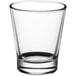 A clear Acopa shot glass with a curved rim.