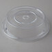A Carlisle clear polycarbonate plate cover over a plate on a table.