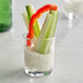 An Acopa shot glass filled with vegetables and dip.