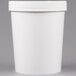 A white Huhtamaki paper food cup with a vented paper lid.