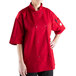 A woman wearing a Mercer Culinary red chef coat with a full mesh back.