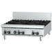 A stainless steel Garland countertop gas range with a griddle over four burners.