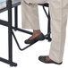 A person using a Safco AlphaBetter Stand Up Desk with their feet.