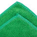 A green Unger SmartColor microfiber towel with white stitching.