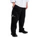 A person wearing black Chef Revival cargo pants and a white shirt.