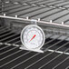 A Taylor oven thermometer on a rack.