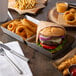 A Tablecraft stainless steel tray holding a burger and fries.