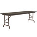 A rectangular Correll folding table with a walnut top and metal frame.