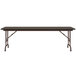 A walnut Correll folding table with a brown metal frame.