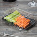 A Fineline plastic snack tray filled with vegetables.