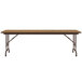 A Correll rectangular folding table with a wooden top and metal legs.
