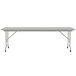 A Correll white rectangular folding table with gray legs.