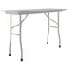 A white rectangular Correll folding table with gray legs.