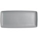 A rectangular Tuxton China tray with a textured gray and white design.