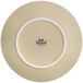 A white Tuxton china plate with a beige matte finish and a logo on the back.