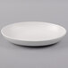 A TuxTrendz Zion matte white china bowl on a gray surface.
