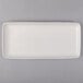 A white rectangular Tuxton china tray with an embossed border.