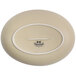A Tuxton matte beige oval china bowl with an embossed white oval logo with black text.