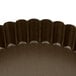 A Gobel fluted brown non-stick tart pan with a removable bottom.
