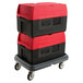 Two Metro Mightylite BigBoy EPP food pan carriers with red lids and a dolly.