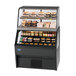 A black Federal Industries refrigerated and heated dual temperature merchandiser with food on display.