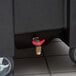A red valve on a black Replacement Faucet Drain container.