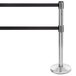 A Lancaster Table & Seating chrome stanchion with black tape on the retractable belts.