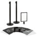 A black Lancaster Table & Seating stanchion post with clear covers on black and white signs.