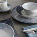 A table set with Schonwald Shabby Chic porcelain plates and cups, including a blue and white bowl with a blue rim.