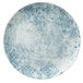 A Schonwald round porcelain coupe plate with blue and white ornaments on a blue background.