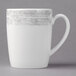 A white porcelain mug with a grey rim and handle.