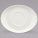 A white oval porcelain saucer with a round edge.