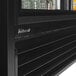 A black Turbo Air refrigerated merchandiser with glass doors and shelves.