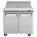 A Turbo Air stainless steel refrigerated sandwich prep table with two doors open.
