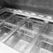 A Turbo Air stainless steel refrigerated sandwich prep table with food trays inside.