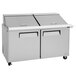 A Turbo Air stainless steel refrigerated sandwich prep table with two doors on a counter.