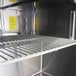 A Turbo Air stainless steel shelf inside a refrigerated sandwich prep table.