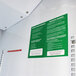 A white wall with green and white labels.