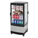 A Turbo Air countertop display refrigerator with drinks and snacks behind glass.